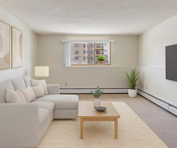 An empty living room with carpeting and a door to the balcony at Gateway Square. 