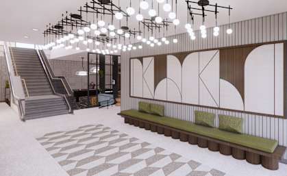 A modern interior with a staircase, a bench, and a patterned floor. at Arcata Apartments, Minnesota