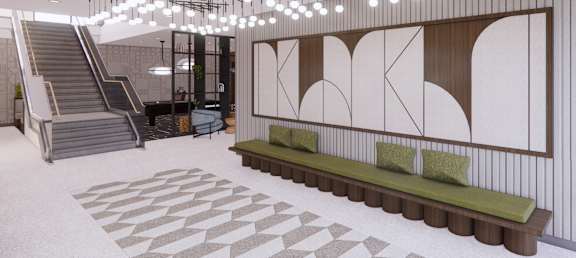 A modern interior with a staircase, a bench, and a patterned floor.
