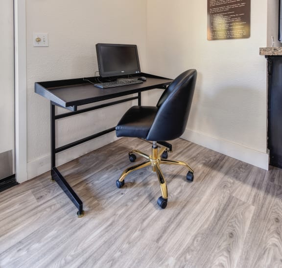 Computer and desk with chair for residents to work on personal business related items inside the clubhouse.at Fountains of Fair Oaks, California