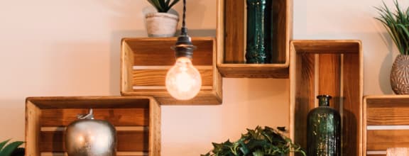 a piece of wall art with wooden crates and pendant lights