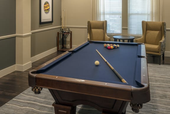 a rec room with a pool table and chairs at Wheatley Senior Living San Antonio