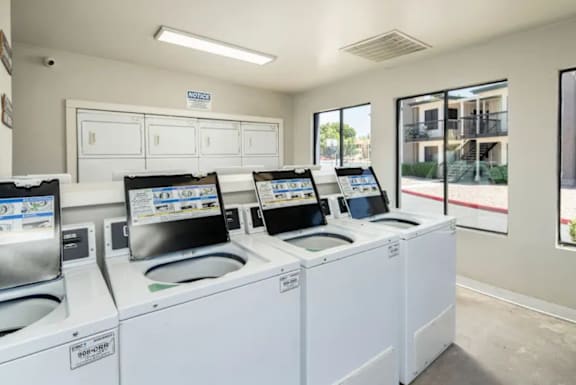 A row of washing machines in a laundromat.