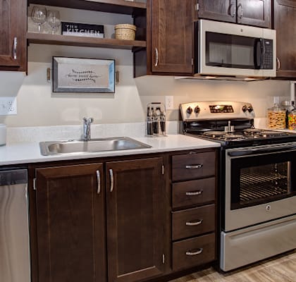 Kitchen with wooden cabinets at Commons at Redwood Creek Apartments, Beaverton, OR