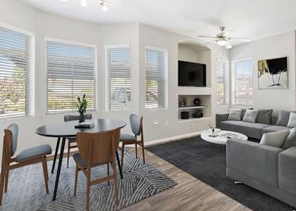 a living room with a couch and a table and chairs
