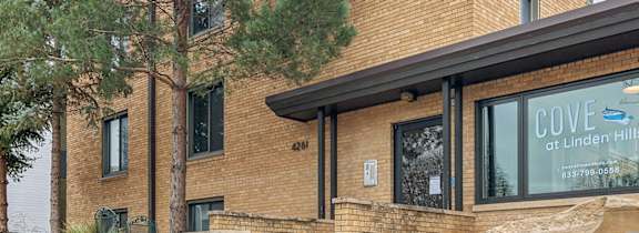A building with a sign that says Cove at Linden Hills.