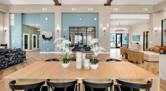 A dining room with a wooden table and chairs.