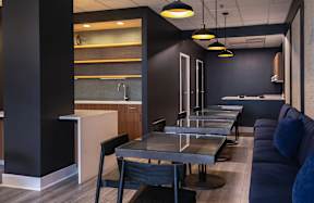 A modern kitchen with a dining table and chairs.