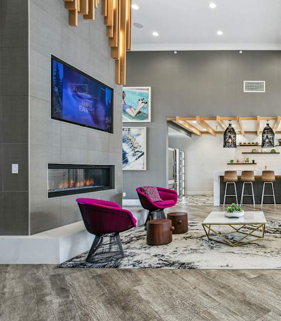 A modern living room with a fireplace and a television.