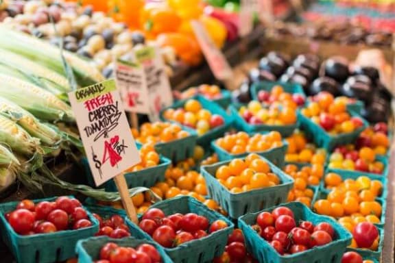 a display in a grocery store filled with lots of fresh produce