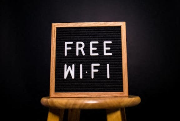 a free wifi sign on a wooden stool
