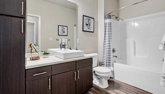 A bathroom with a white sink, toilet, and bathtub.