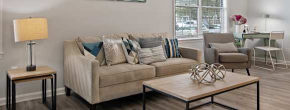 A living room with a couch, chair, and coffee table.