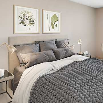 A bedroom with a large bed and a window with blinds.