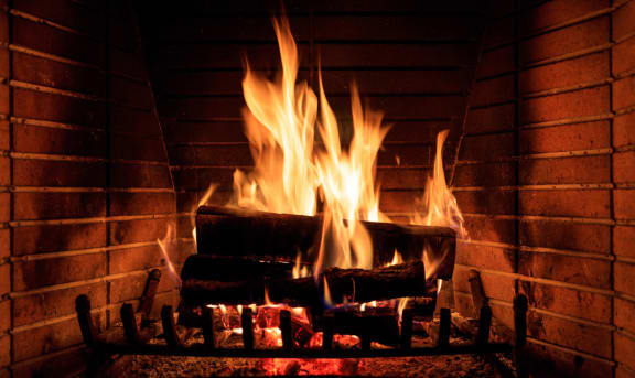 a roaring fire in a brick fireplace
