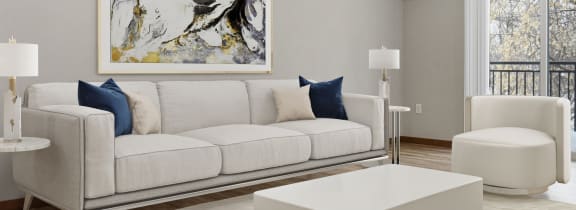 a living room with a white couch and coffee table on a white rug