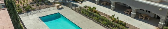 A swimming pool in front of apartment buildings.