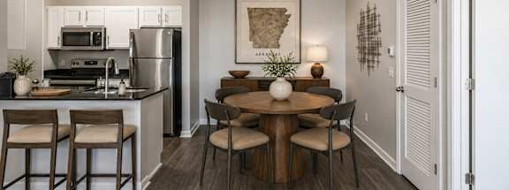 A kitchen with a table and chairs in the middle of the room.