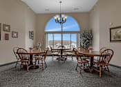 Thumbnail 5 of 11 - a dining room with a table and chairs and a large window at Savanna Apartments, St Cloud, MN, 56303