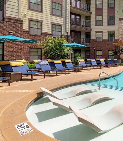 Swimming pool with tanning ledge with chairs at 1010 Dilworth, Charlotte, NC
