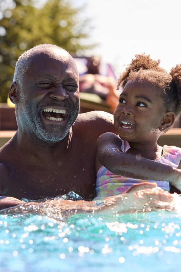 a man and a child swimming in a pool
