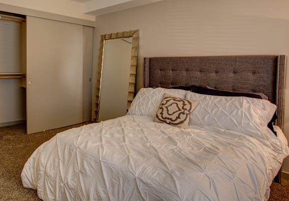 Bedroom with cozy bed at Commons at Redwood Creek Apartments, Beaverton, Oregon