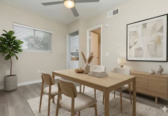 A dining room with a wooden table and chairs.