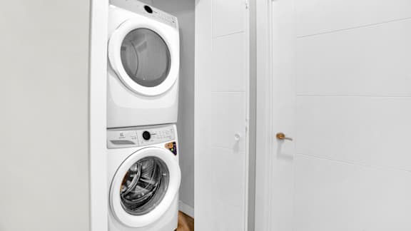 A white washing machine and dryer in a small laundry room.
