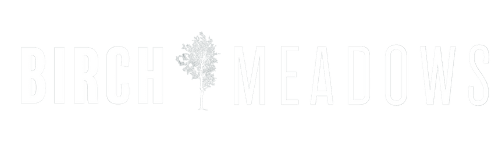the white logo of the Birch Meadows apartments on a black background