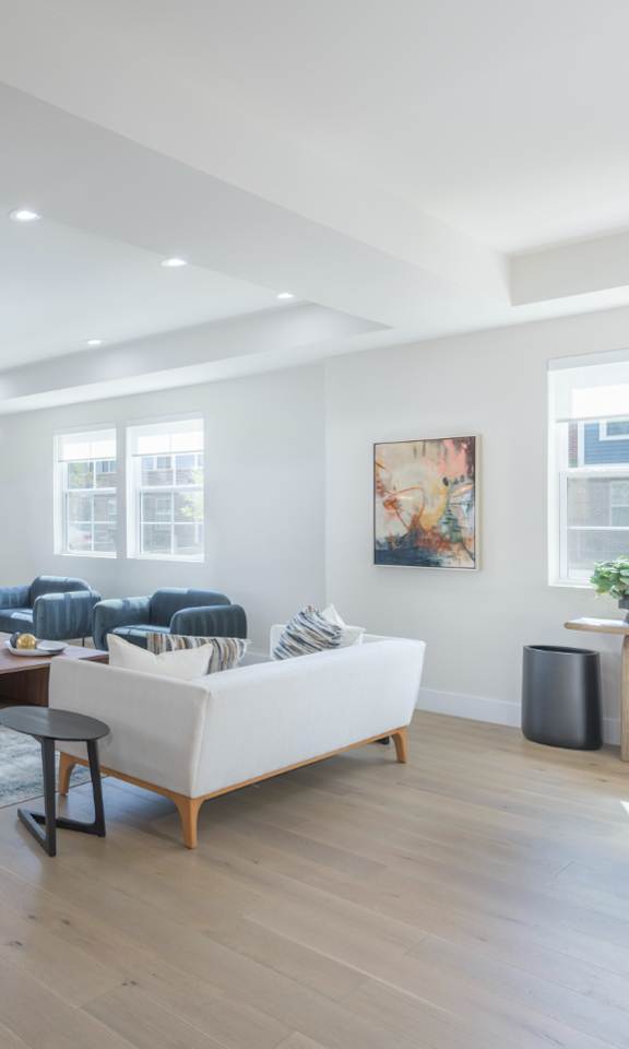 A spacious living room with a pool table and a couch.