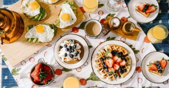 a table topped with plates of breakfast food