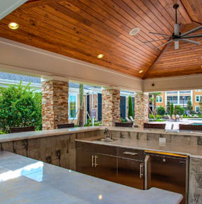 a patio with tables and chairs and a pool