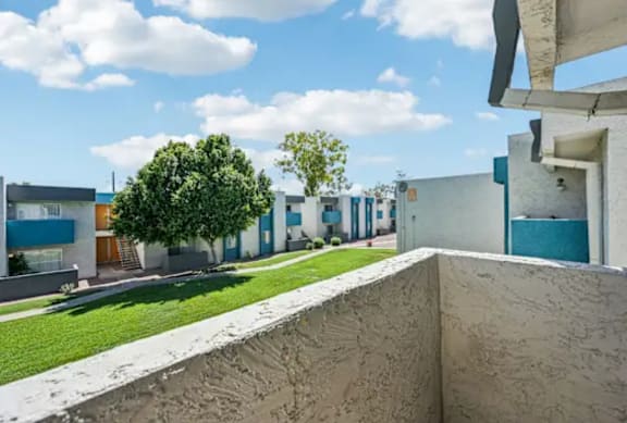 A view of a building with a tree in the background.