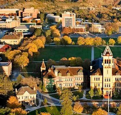 an aerial view of the campus with mountains in the