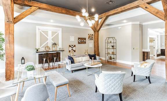 a living room with a vaulted ceiling and exposed wooden beams