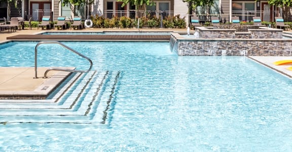 our apartments have a resort style pool with lounge chairs and tables