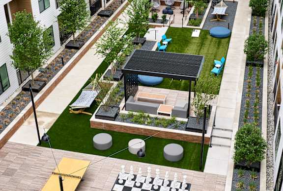 A rooftop patio with a chess board and a black and white checkerboard.