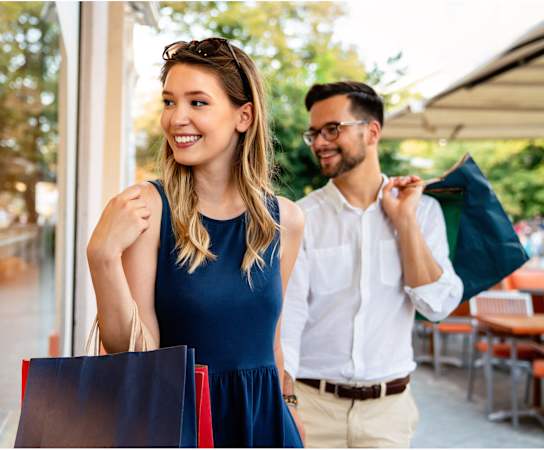 a man and a woman walking down the street with shopping bags at Links at High Resort, New Mexico