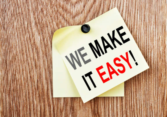 a sticky note with the words we make it easy written on it
