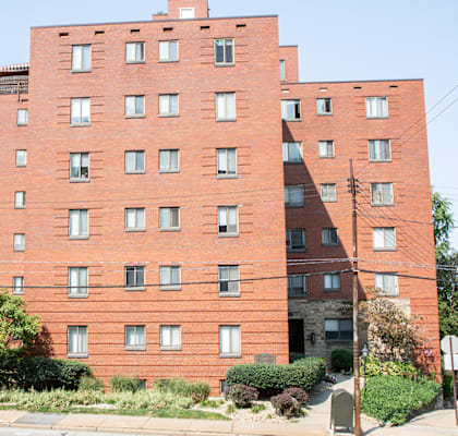 a tall brick building on the side of a street