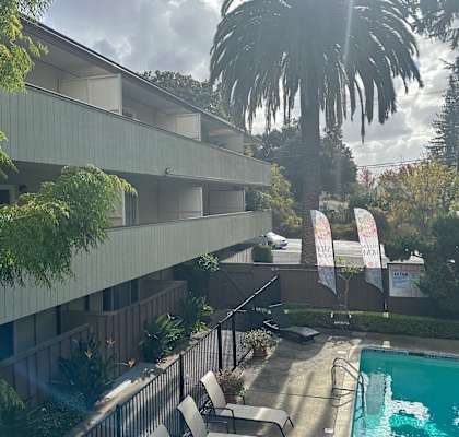 A pool area with a building in the background.