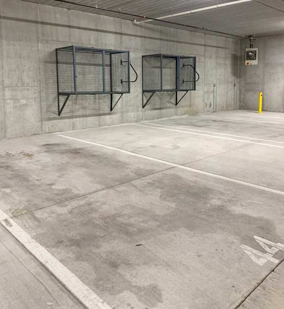 an underground climate-controlled parking garage with wall-mounted storage