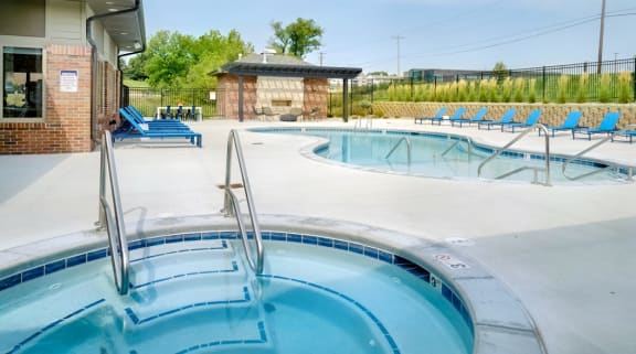 Resort style pool with lounge chairs outside the clubhouse at The Flats at Shadow Creek
