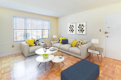 A living room with a couch, coffee table, and pictures on the wall.