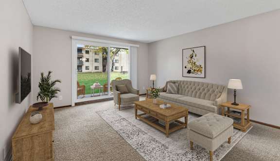 A living room with a grey couch, a wooden coffee table, and a flat screen TV mounted on the wall.