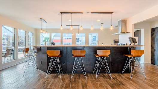 a kitchen with a counter top and bar stools