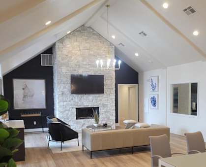 a living room with a vaulted ceiling and hardwood flooring