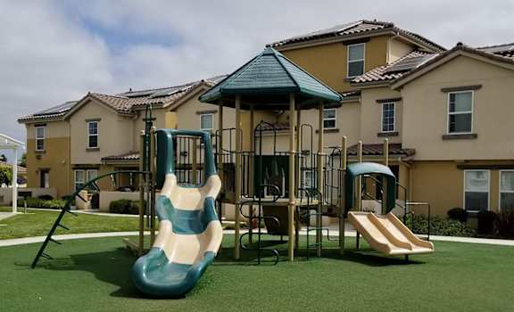 Tresor Apartments playground showing slides, climbing bars, with covered roof