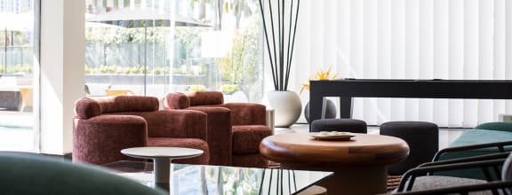 a living room with furniture and a large window at The Flat, Los Angeles, CA