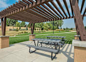 Thumbnail 29 of 53 - Outdoor picnic area underneath a pergola near the private walking path.